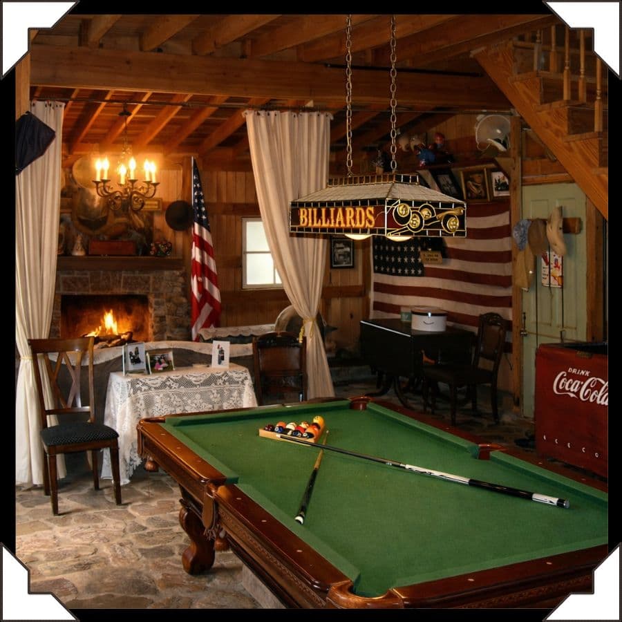 A cozy game room featuring a pool table, a fireplace, and Americana decor.