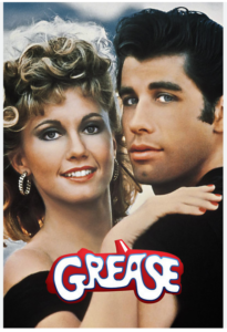 photo of Olivia Newton John and John Travolta in character for the movie Grease. Grease is written at the bottom of the photo in red and white letters