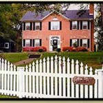 red brick georgian coloniual with black shutters-white picket fence in forground The Rosevine Inn