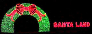 black background green arch with a red bow and the words SANTA LAND in red letters beside it